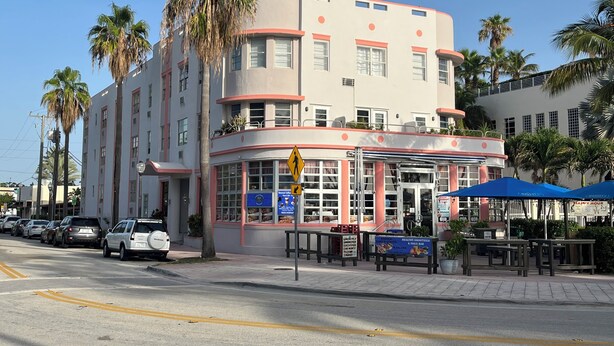 A multi-story building with a distinctive architectural style, featuring rounded corners and a balcony. - Charming studio in sunny Miami Beach with ocean view! (Miami Beach)