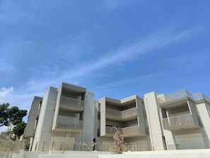 Stylish building with balconies and minimalist design.