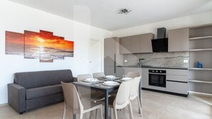 A modern kitchen with grey cabinets, a black oven, and a marble backsplash. - Holiday home ELEA is the 2025 novelty that will give you a holiday in Pineto but with the charm of a new modern construction, fresh and designed with all the comforts. The Calipso apartment has a large living room with kitchenette and sofa bed at the ent (Pineto)