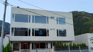 A two-story hotel with a modern design, featuring large windows and a sign indicating it is a SHANNON hotel.
