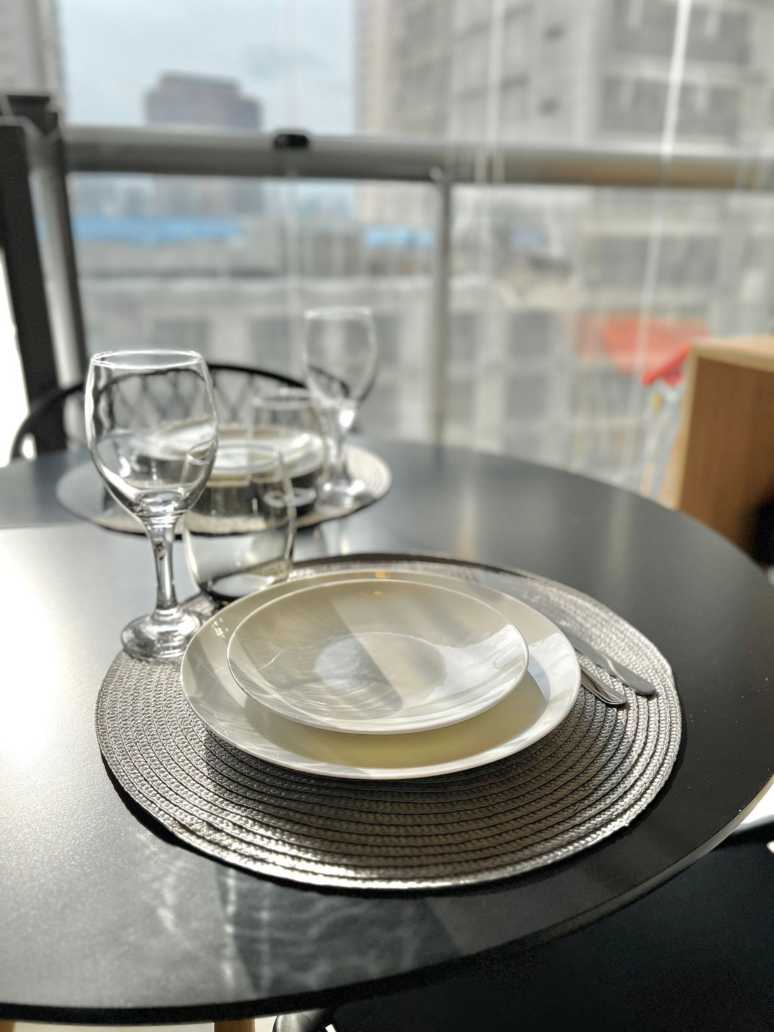 Une table à manger avec une assiette, un verre et une fourchette.