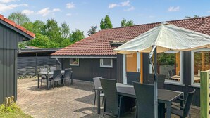 A patio area with outdoor furniture and a covered seating area. - Awesome home in Væggerløse with WiFi (Væggerløse)
