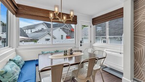 A sunroom with a dining table, chairs, and a bench with cushions. - 2Blocks 2Beach | Free Coffee | Linens+Towels | AC (Belmar)
