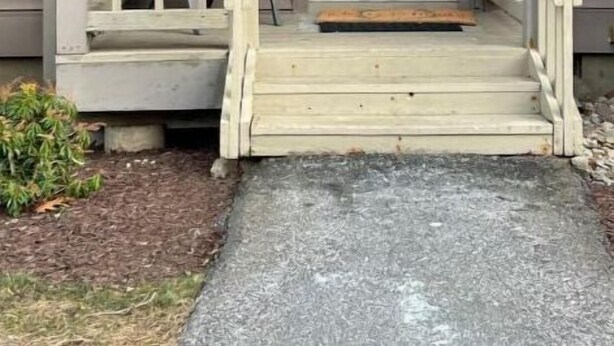 A house with a front porch, a door with a wreath, and a mailbox. - Poconos Dream House (East Stroudsburg)