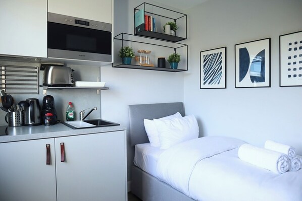 1 bedroom, desk, iron/ironing board, travel crib