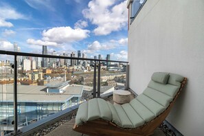 A balcony with a lounge chair and a city view. - Stunning Thames View 2BR Apartment 2 Baths 2 Balconies Sleeps 6 (Greater London)