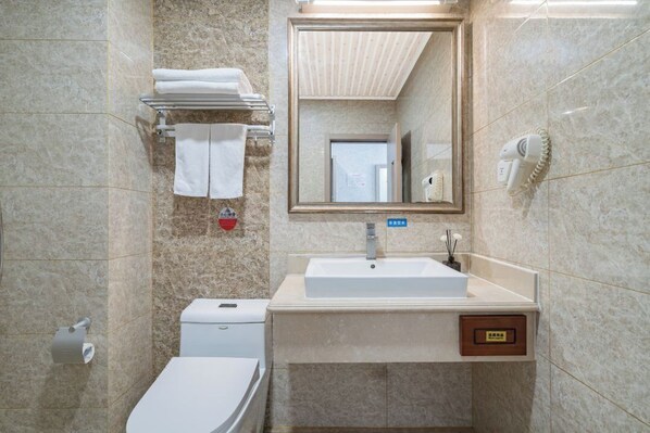 A bathroom with a sink, mirror, towel rack, and toilet. - LAN WAN INTERNATIONAL HOTEL (Beijing)
