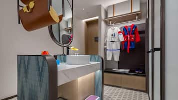 A modern bathroom with a large mirror, a sink, a toilet, and a shower area.