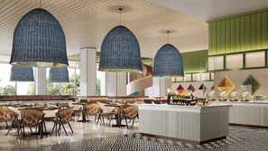 A modern dining area with high ceilings, unique hanging light fixtures, and a buffet setup. - Even Yining By Ihg (Yining)
