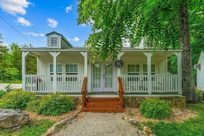 A white building with a porch, a sign reading 'Max's Boathouse,' and a wooden staircase leading to the entrance. - Nature-Focused Getaway | Pool + Creekside Retreat (Blue Eye)