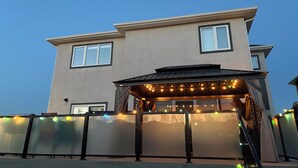 A two-story house with a covered patio area.