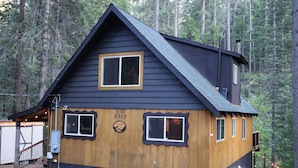 A cabin with a dark roof, a wooden front section, and a number '2373' on the wall. - Creekside Cabin+Fire Pit+Lakes Nearby+Wine Tasting+Bear Valley Ski Resort (Arnold)