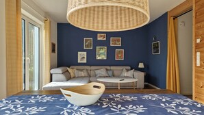 A room with a sofa, a small round table, a bowl, and wall art. - Holiday Home 'Sonnenweide, 85qm' with Private Terrace, Shared Garden and Wi-Fi (Salem)