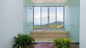 A bathroom with a large window, a bench, and potted plants. - Outstanding ocean view, 4 bdr, jungle villa! (Uvita)