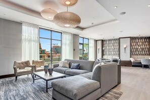 Relax in comfort with a spacious layout, featuring a sofa, armchairs, and a separate dining area.