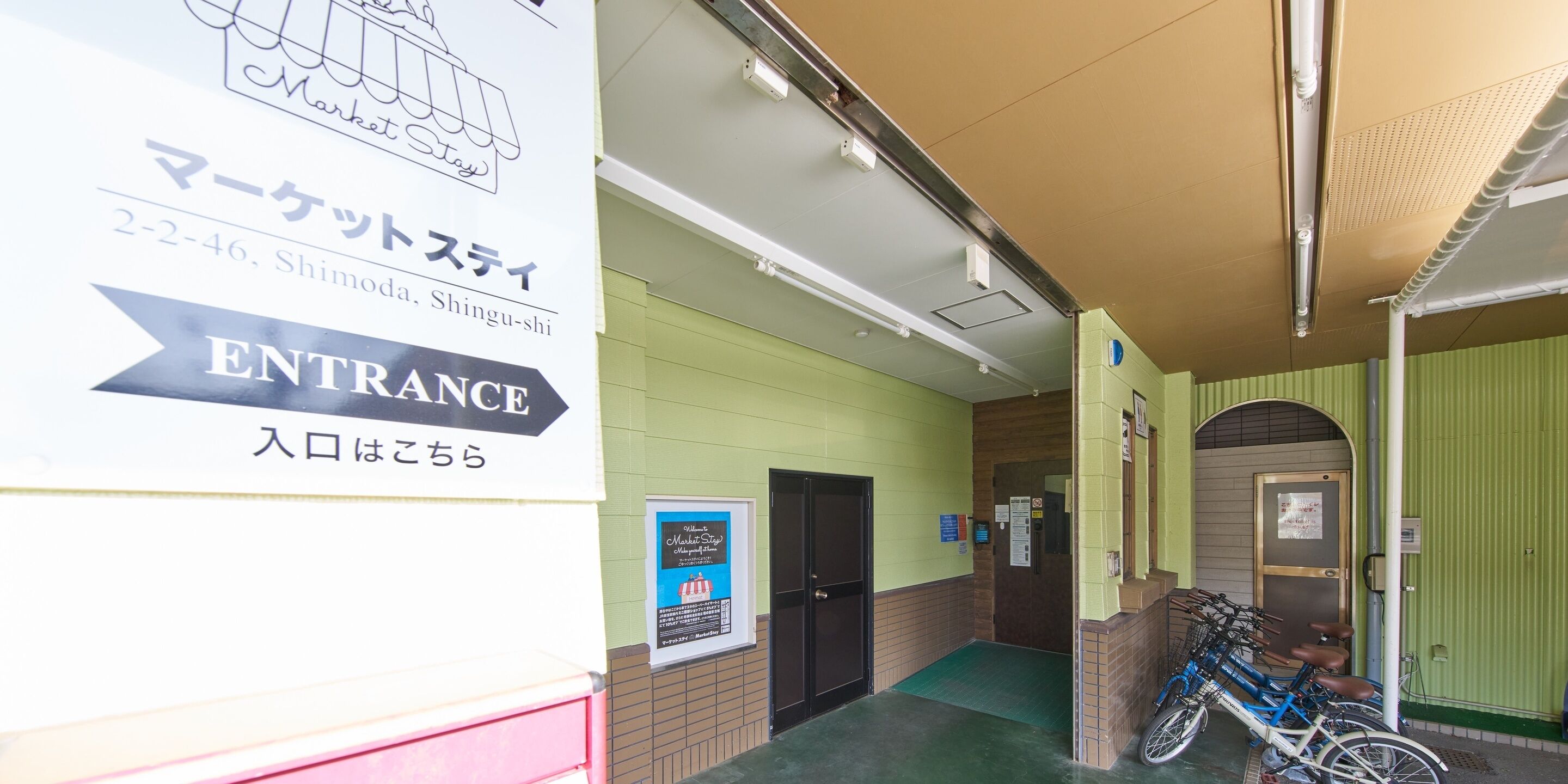 A hotel entrance with a sign indicating the location.