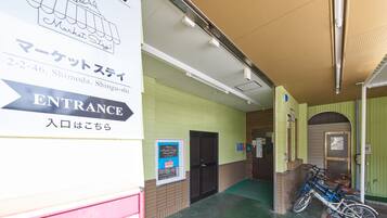 A hotel entrance with a sign indicating the location.