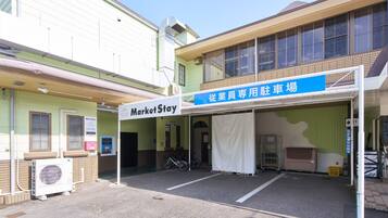 A building with a MarketStay sign, a covered parking area, and a bicycle parked outside.