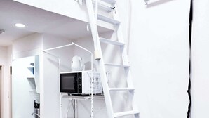 A compact kitchen with a microwave, coffee maker, and a white refrigerator. - Triphome Koenji Minami 4 mins Higashi Koenji stn (Suginami City)