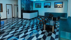 A lobby with a check-in counter, seating area, and patterned floor. - Hotel Shree Udai Vilas (Udaipur)