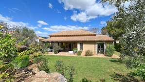 A house with a tiled roof, a covered porch, and a well-maintained lawn. - Alondra - Javea, Costa Blanca (Javea)