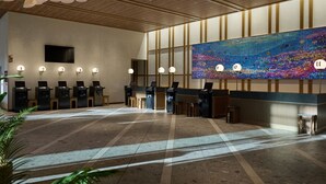 A spacious lobby with a large mosaic wall, multiple reception desks, and pendant lighting. - The Royal Park Hotel Maihama Resort Tokyo Bay (Urayasu)