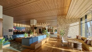 A spacious lobby with a wooden ceiling, a stone accent wall, and a large seating area with sofas and a coffee table. - The Royal Park Hotel Maihama Resort Tokyo Bay (Urayasu)