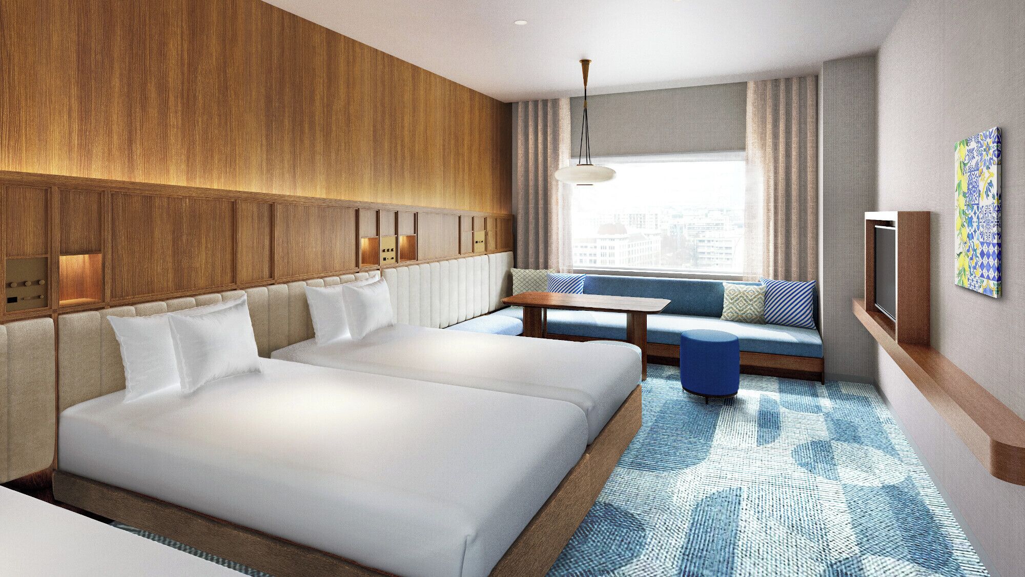 A hotel room with a large bed, a seating area, a television, and a city view.