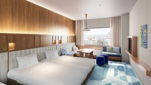 A modern hotel room with a large bed, a sofa, a small table, and a city view through the window. - The Royal Park Hotel Maihama Resort Tokyo Bay (Urayasu)