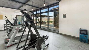 A gym with treadmills, a stationary bike, and a rowing machine. - Risco 305: Downtown, Rooftop Pool, & Beach Access (Bucerías)