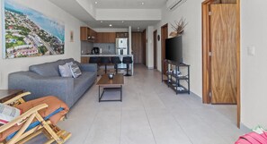 A modern apartment with a living room, kitchen, and dining area. - 2BR, Rooftop Pool w/ Views, & Parking: Vista 101 (Bucerías)