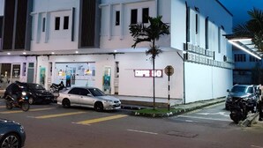 A multi-story building with a flat facade, large windows, and a visible storefront with signage. - The Ardens Hotel - Pekan Nenas (Pekan Nanas)