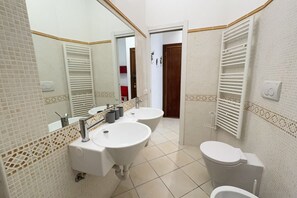 Een douche, een haardroger, een bidet, handdoeken