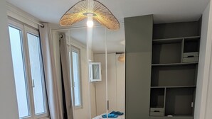 Une chambre à coucher avec un lit, une armoire et un miroir.