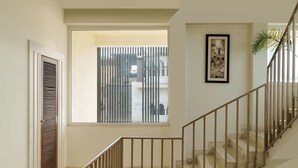 Un escalier avec une rampe métallique menant à l’étage supérieur.