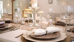 A table set for a formal dinner with clear glassware, white napkins, and a centerpiece candle. - Luxury Villa Malo (Seget)