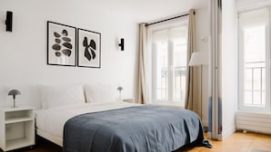 A bedroom with a bed, bedside tables, a window with curtains, and wall-mounted artwork. - Blueground | Gros-Caillou, view, nr Eiffel Tower (Paris)