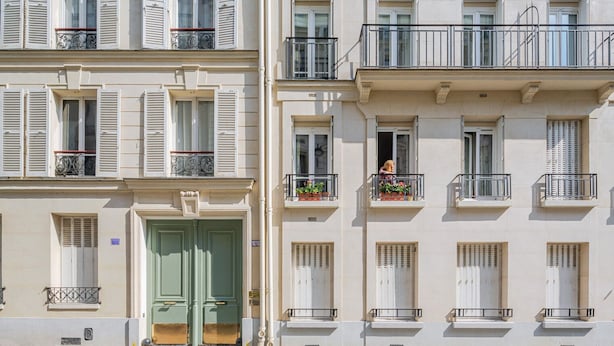 A row of classic European townhouses with white facades, shutters, and balconies. - Blueground | Gros-Caillou, view, nr Eiffel Tower (Paris)