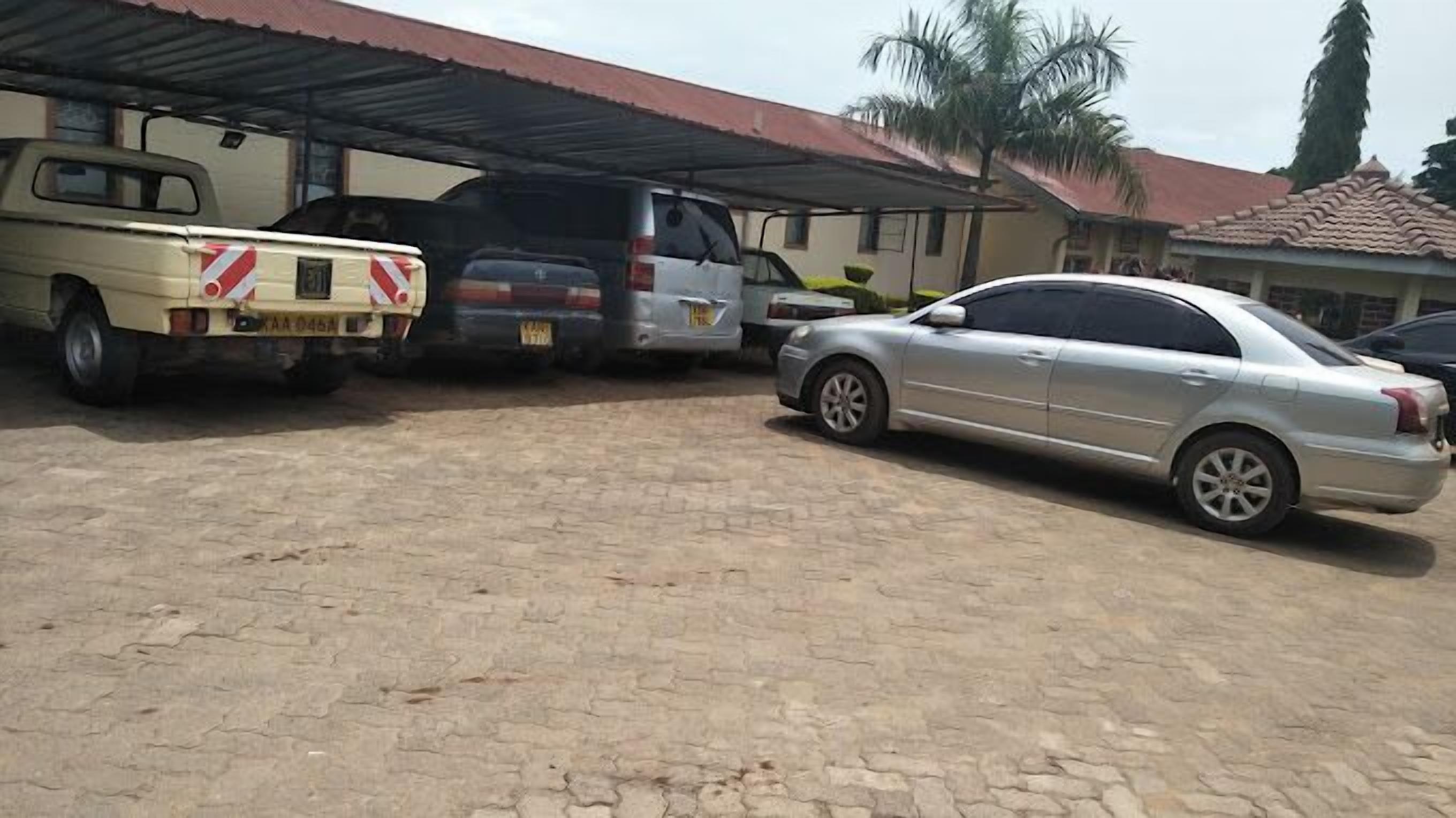 A parking area with a pickup truck, a van, and a sedan.