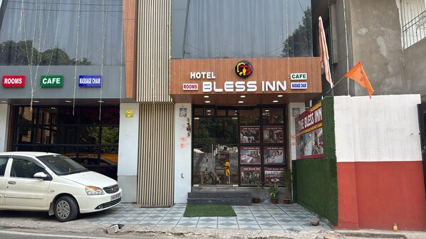 A hotel named 'The Bliss Inn' with signs for rooms, cafe, and massage chair.