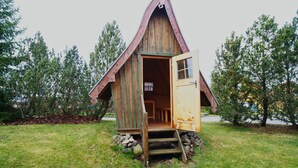 A wooden cabin with a steeply pitched roof and a door open to the interior. - Your Holiday Home With Fireplace in the Harz (Oberharz am Brocken)