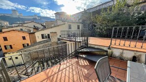 A rooftop terrace with a view of historic buildings and a castle in the background. - 6 Guests apt With Terrace in Pedestrian Historic Centre of Spoleto (Spoleto)