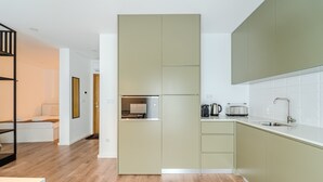 A modern kitchen with a built-in oven, a coffee maker, and a toaster. - LZ Studio by House and People (Braga)