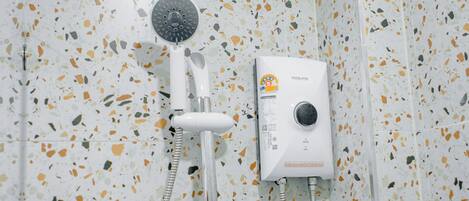 A shower with a handheld showerhead and a wall-mounted control panel.
