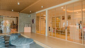 A modern interior with a reception desk, seating area, and a reception sign. - Baan Cocoa Boutique Hotel (Takua Thung)