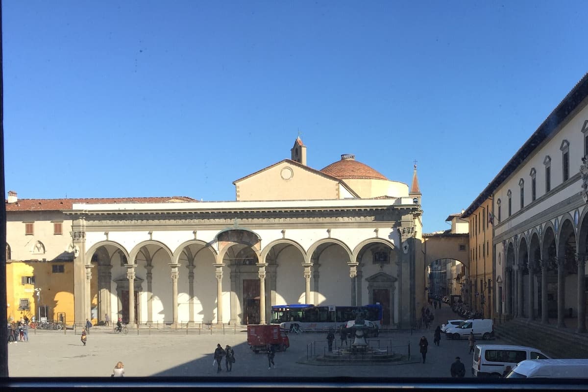 A historic building with a central courtyard, arches, and a dome.