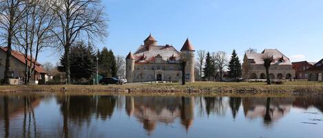 A historic building with a central tower and a moat.
