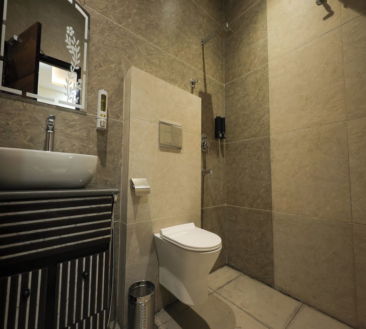 A modern bathroom with a large sink, toilet, and shower.