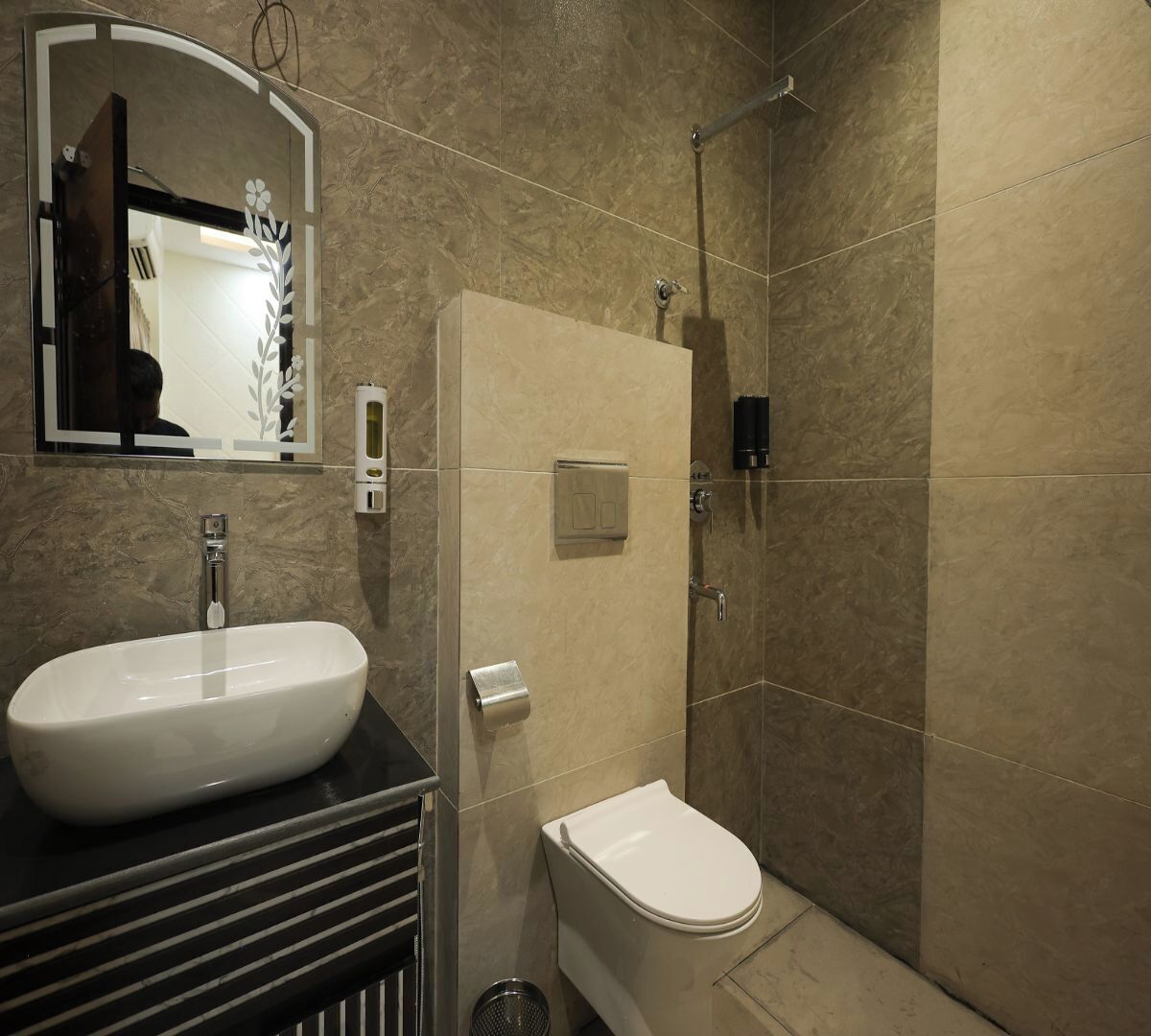 A bathroom with a white sink, a toilet, and a shower.