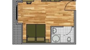 A kitchen with a wooden floor, a sink, a stove, and a refrigerator.